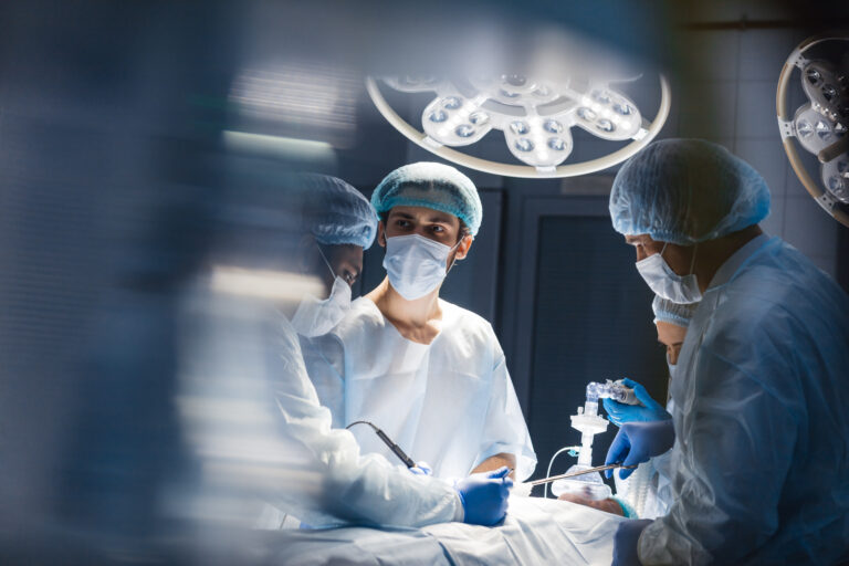 Blurred background with team surgeon at work in operating room