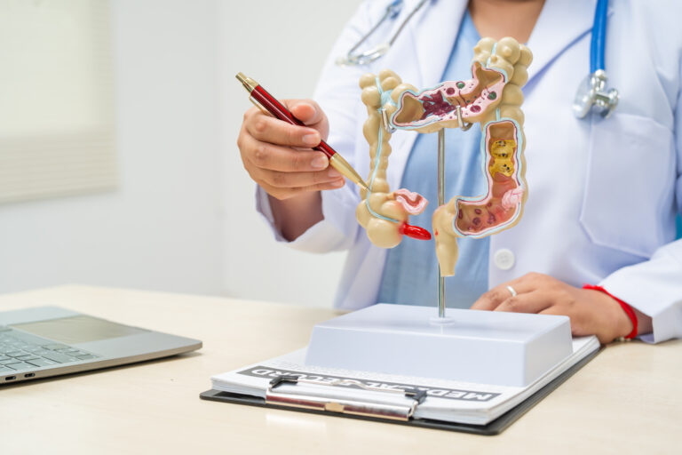 A female doctor sits at a table in a hospital, discussing intest