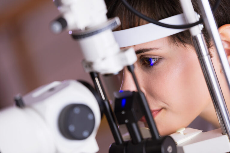 Optometrist examining patient in modern ophthalmology clinic