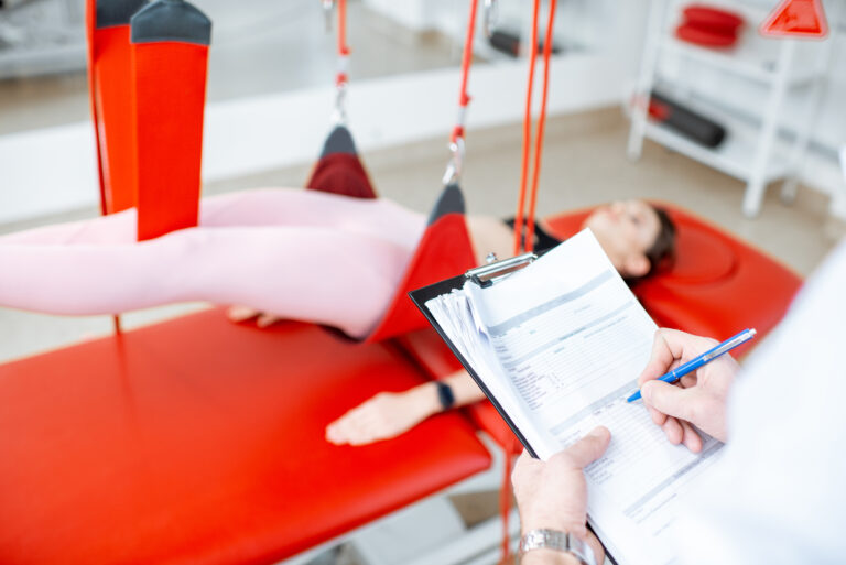 Physiotherapist writing medical results
