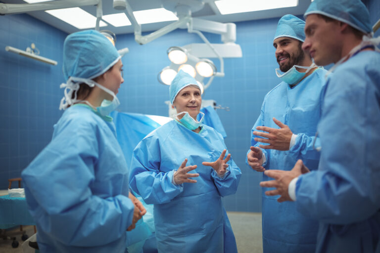Team of surgeons having discussion in operation theater